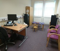 A room with a table and chairs, with testing equipment