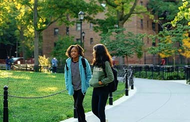 Shows two girls walking outside together