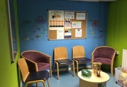 A colour waiting room with chairs and toys to play with