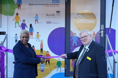 Jackie Small and Neil Carr cutting the ribbon to launch the research bus