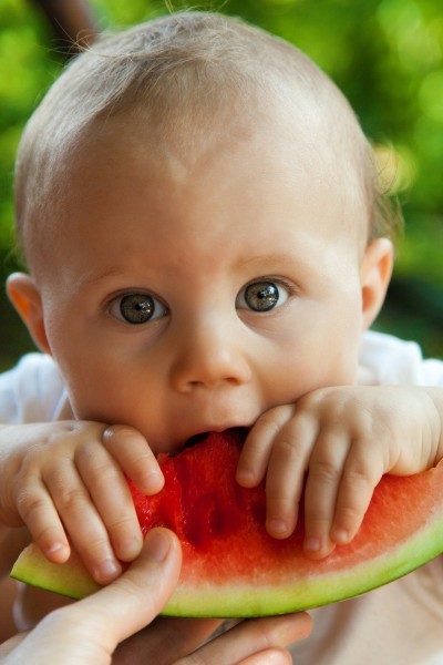 Baby eating melon