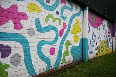 Image shows part of the garden mural painted onto a wall at Milford Ward.