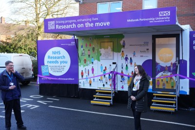 Colleagues stand in front of the research bus