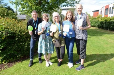 Image shows the Arts for Health team stood together in a garden area.